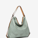 Convertible bag into a backpack in green die-cut leather