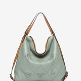 Convertible bag into a backpack in green die-cut leather