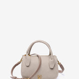 Kleine Handtasche aus recycelten Materialien in Beige.