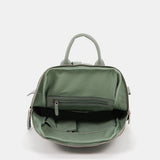 Damentasche aus grünem gestanztem Leder.