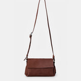 Brown leather crossbody bag.