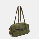 Grüne Schultertasche aus Veloursleder.