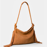 Shoulder bag in cognac leather with fringe details.