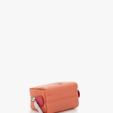 Small women's leather toiletry bag with orange die-cut logo