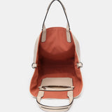 Umhängetasche für Damen, wendbar in Orange.