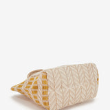 Strandtasche mit gelbem Muster.