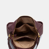 Burgundy shoulder bag made from recycled materials.